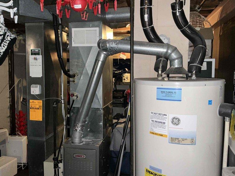 Conducted comprehensive assessment of existing HVAC system, including Lennox furnace unit and associated ductwork in basement utility room. Documented current installation configuration with attention to exhaust ventilation and connection points. Evaluated exterior equipment placement and protective measures currently implemented for winter conditions.