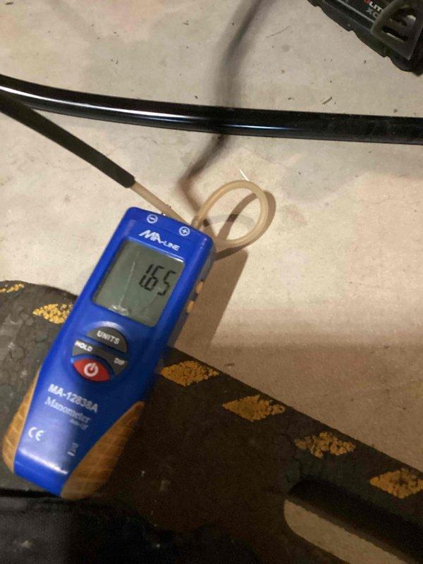 Completed installation of complete HVAC system with successful pressure testing. System static pressure measured at 0.00 WC initially, with final static pressure reading of 16.5 WC verified using MA-Line digital manometer (models MA-12638A and MA-PS285A), confirming proper system pressurization and absence of leaks.