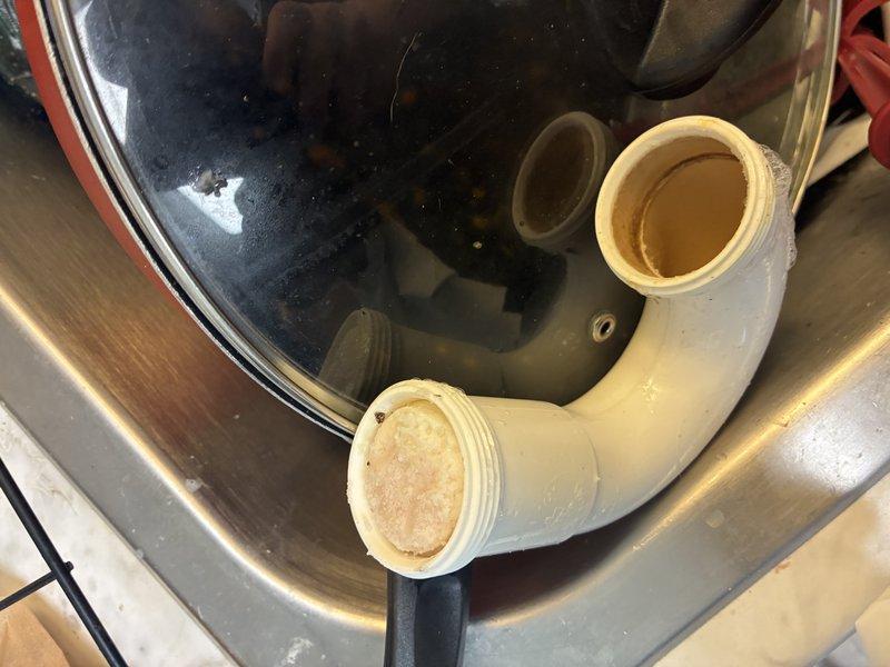 Removed and replaced damaged drain pipe from garbage disposal unit due to internal corrosion and residue buildup. Successfully installed new PVC pipe components and reconnected the black disposal unit to the drainage system, ensuring proper alignment and secure connections throughout the assembly.