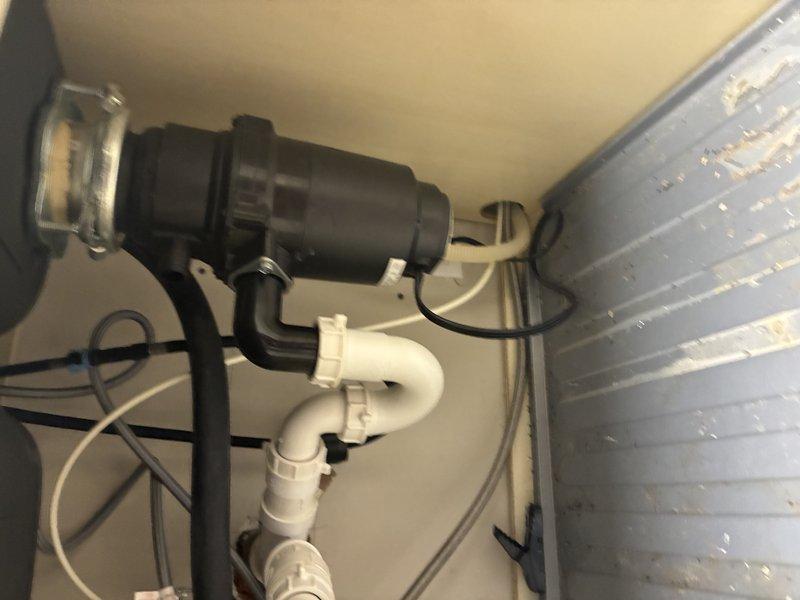 Removed and replaced damaged drain pipe from garbage disposal unit due to internal corrosion and residue buildup. Successfully installed new PVC pipe components and reconnected the black disposal unit to the drainage system, ensuring proper alignment and secure connections throughout the assembly.