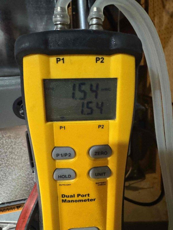 Performed routine HVAC tune-up service including electrical inspection with multimeter (SC260) showing 0.45 AC voltage reading within normal parameters. Conducted pressure testing using dual port manometer with readings of 154 on both ports, verifying proper system pressure balance. All measurements were within manufacturer specifications, confirming system is operating efficiently.