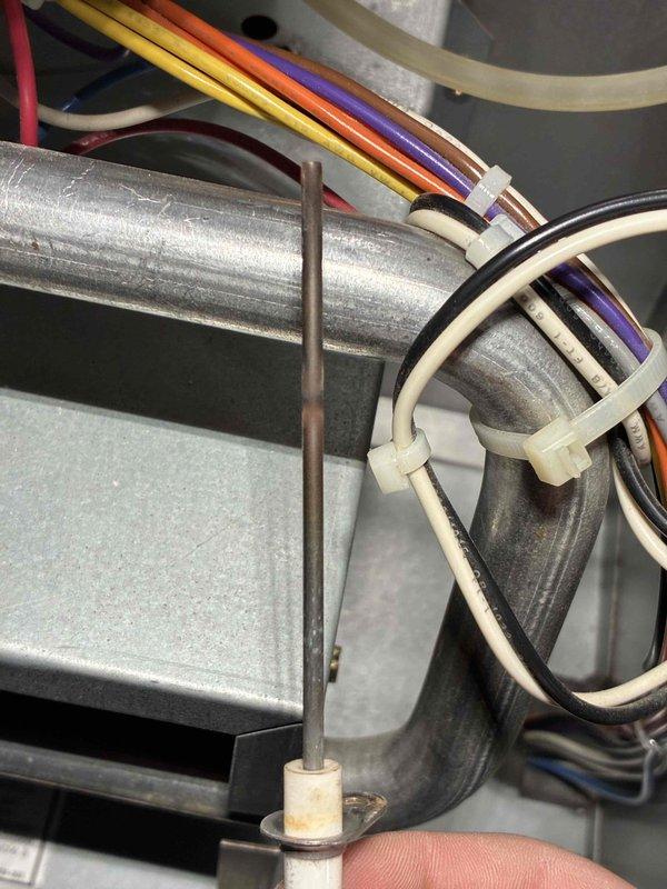 Performed scheduled prepaid maintenance visit on HVAC system. Inspected electrical connections and wiring, confirming proper installation with secure zip ties. Measured supply air temperature at 117.3°F using UEi PDT650 thermometer, verifying system is operating within normal temperature range.