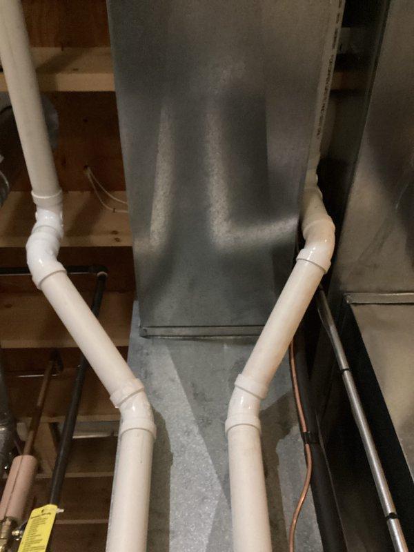 Performed comprehensive tune-up on HVAC system, inspecting ductwork throughout unfinished basement area. Examined connections between metal ducts and PVC condensate lines, verifying proper installation and sealing at all junction points. No issues identified with the existing ductwork configuration or drainage system.