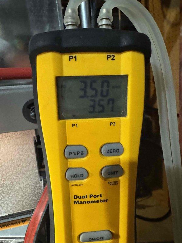 Performed routine HVAC tune-up service on residential furnace system. Completed diagnostic pressure testing with dual port manometer, obtaining readings of 350/359, confirming system is operating within manufacturer specifications. Inspected internal components with access panel removed, verified proper connection of PVC exhaust/intake piping, and examined electrical connections and condensate drainage system.