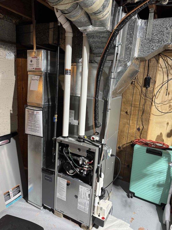 Performed routine HVAC tune-up service on residential furnace system. Completed diagnostic pressure testing with dual port manometer, obtaining readings of 350/359, confirming system is operating within manufacturer specifications. Inspected internal components with access panel removed, verified proper connection of PVC exhaust/intake piping, and examined electrical connections and condensate drainage system.