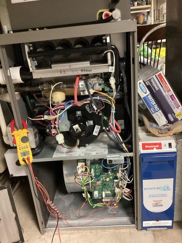 Performed comprehensive HVAC system tune-up including inspection of furnace internal components and wiring connections. Tested electrical systems with multimeter to verify proper voltage and functionality. Checked and confirmed Honeywell thermostat operation, noting current temperature (78°) versus set point (70°) to ensure proper communication with the HVAC system.