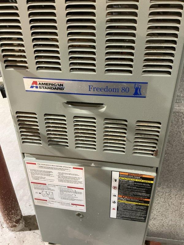 Performed maintenance service on American Standard Freedom 80 furnace. Identified and documented frost/ice formation on evaporator coil indicating potential refrigerant flow issues. Completed visual inspection of unit components and ventilation system to ensure proper operation.