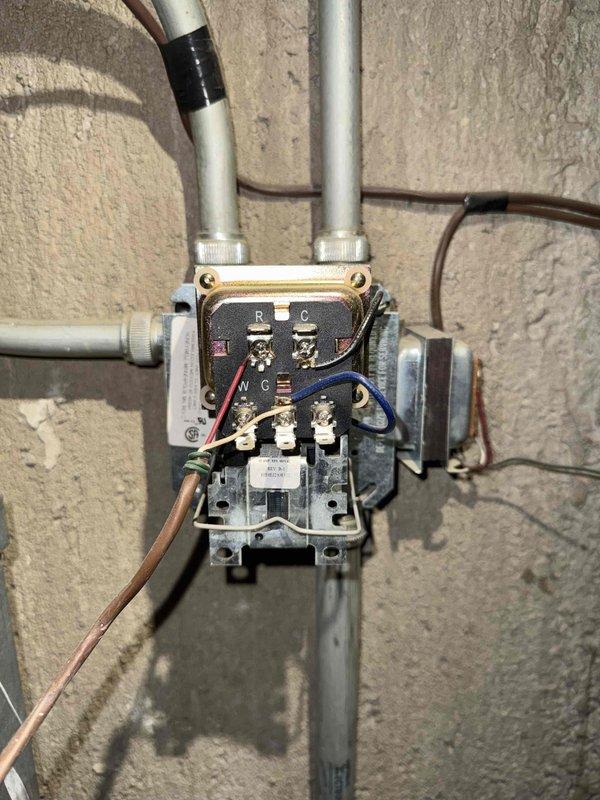 Performed diagnostic testing on furnace control system, identifying loose connections in the thermostat wiring junction box. Reconnected and secured R, C, W, and G terminal wires, then verified proper electrical continuity with multimeter testing at the furnace control board. System now operating within normal parameters with restored heating functionality.