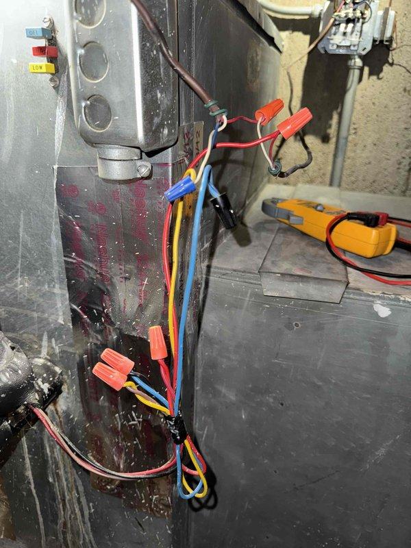 Performed diagnostic testing on furnace control system, identifying loose connections in the thermostat wiring junction box. Reconnected and secured R, C, W, and G terminal wires, then verified proper electrical continuity with multimeter testing at the furnace control board. System now operating within normal parameters with restored heating functionality.