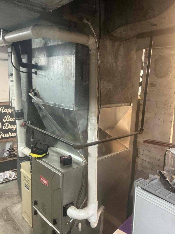 Conducted complete assessment of existing HVAC system consisting of an aging Bryant furnace installed in basement utility room with connected ductwork and PVC exhaust piping, along with outdoor condenser unit positioned on mulched ground adjacent to the home's foundation. Provided comprehensive replacement estimate for full system upgrade including removal of existing equipment, installation of new high-efficiency components, and all necessary modifications to ensure proper operation and code compliance.