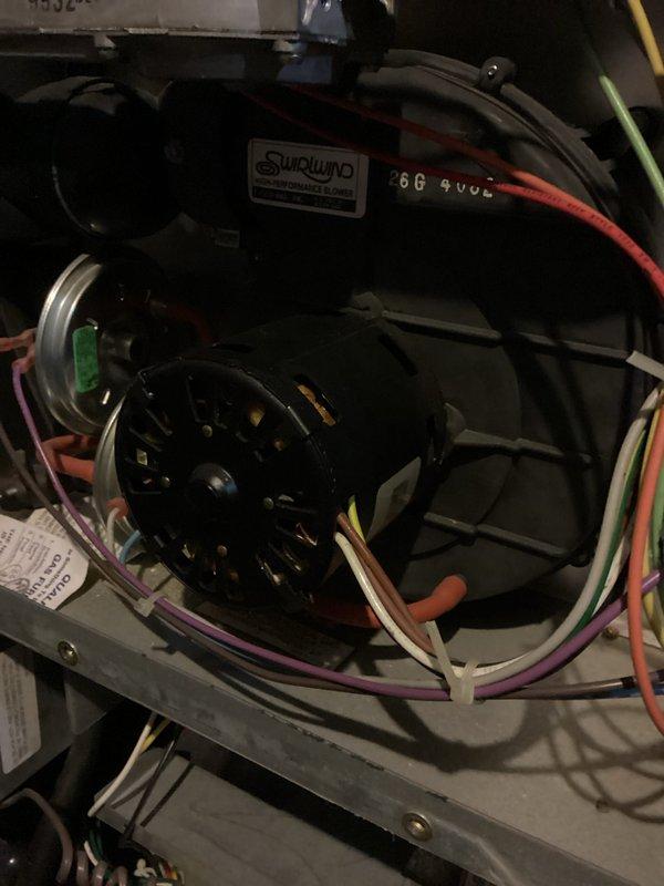 Diagnosed and repaired an older furnace experiencing no-heat condition. Inspection revealed a failing blower motor with visible wear on the mounting bracket and deteriorated wiring connections. Replaced the blower motor assembly and reconnected all electrical components, then verified proper system operation through complete heating cycle test.