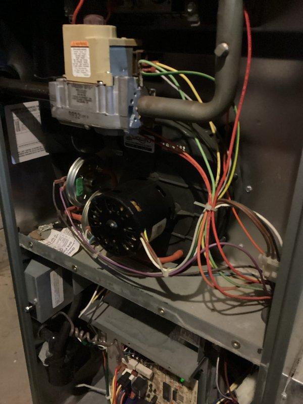 Diagnosed and repaired an older furnace experiencing no-heat condition. Inspection revealed a failing blower motor with visible wear on the mounting bracket and deteriorated wiring connections. Replaced the blower motor assembly and reconnected all electrical components, then verified proper system operation through complete heating cycle test.