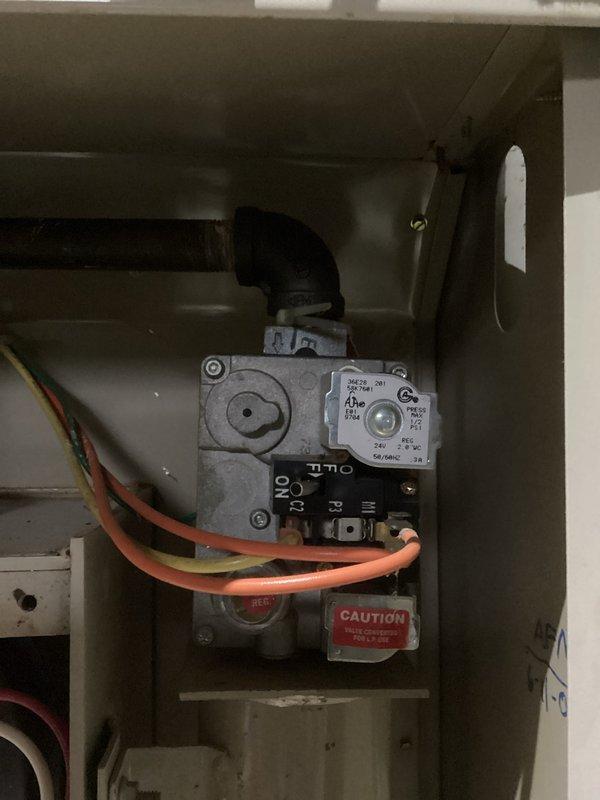 Performed comprehensive tune-up on HVAC system, inspecting gas valve assembly and associated control components. Verified proper operation of gas lines and electrical connections, noting all wiring (orange/yellow) was secure and intact. Examined plumbing connections including PVC and copper piping, checking multiple flow control valves for functionality. All components appeared properly installed with no signs of leakage or damage. System now operating at optimal efficiency.