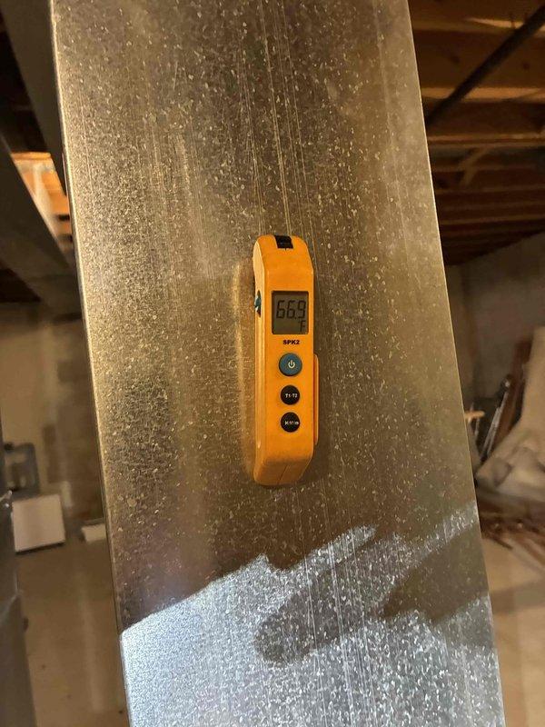 Performed routine maintenance on residential HVAC system. Conducted temperature differential measurements across ductwork using digital thermometer, recording readings of 66.9°F. Completed diagnostic testing of furnace/air handler using probe instrument, inspecting internal components and verifying proper operation of all system functions.