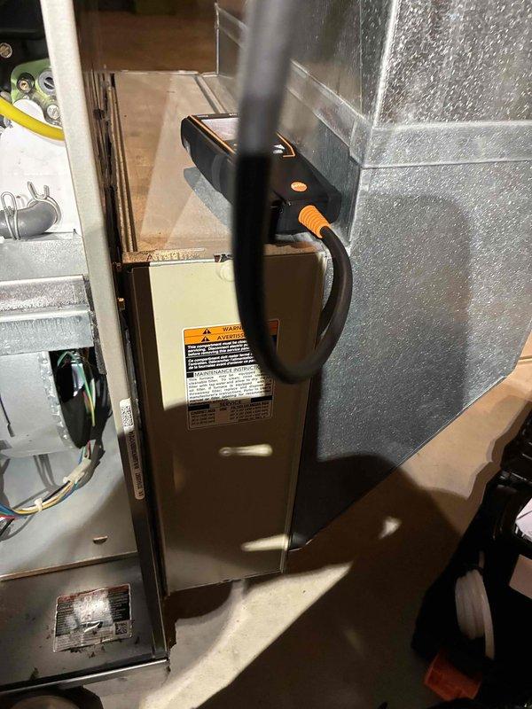 Performed routine maintenance on residential HVAC system. Conducted temperature differential measurements across ductwork using digital thermometer, recording readings of 66.9°F. Completed diagnostic testing of furnace/air handler using probe instrument, inspecting internal components and verifying proper operation of all system functions.