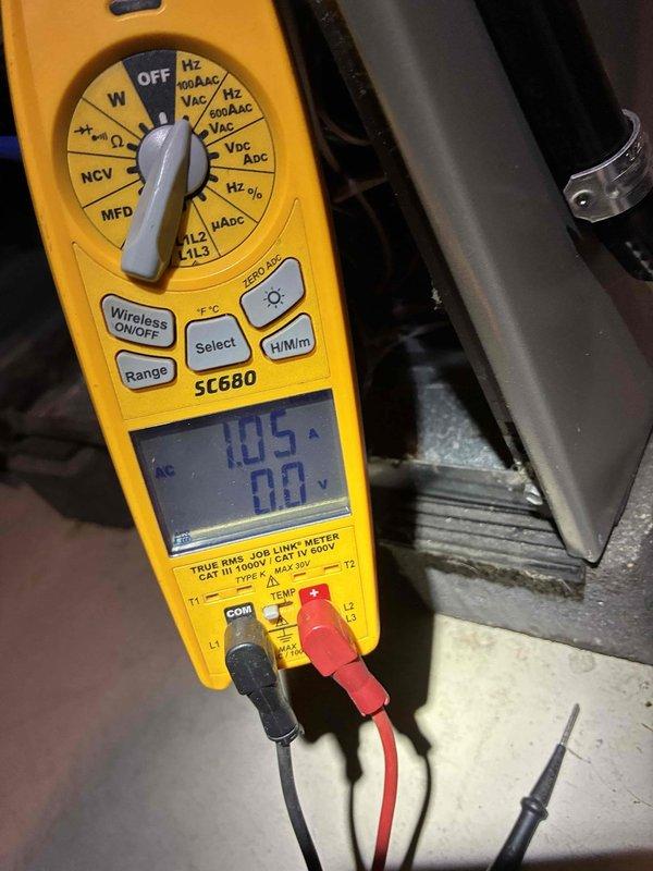 Performed routine maintenance tune-up on HVAC system. Inspected interior metal compartment for wear and debris. Conducted electrical testing using Fieldpiece SC680 clamp meter, confirming amperage reading of 1.05A with voltage verification at 0.0V, indicating proper electrical parameters within manufacturer specifications.