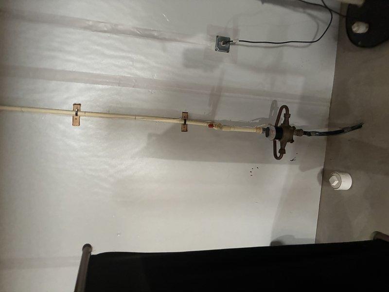 Conducted inspection of existing water heater installation in mechanical room. Evaluated PVC venting system, supply piping, and valve assembly. Documented current plumbing configuration including horizontal PVC pipe with metal bracket supports and functioning valve assembly connected to flexible supply line. Photos taken of complete system to reference for estimate preparation.