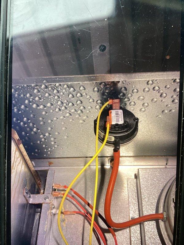 Diagnosed and repaired circuit board failure in aging furnace causing no-heat condition. Identified faulty pressure switch with significant condensation buildup on internal components. Replaced control board and pressure switch assembly, restoring proper heating operation after thorough system testing.