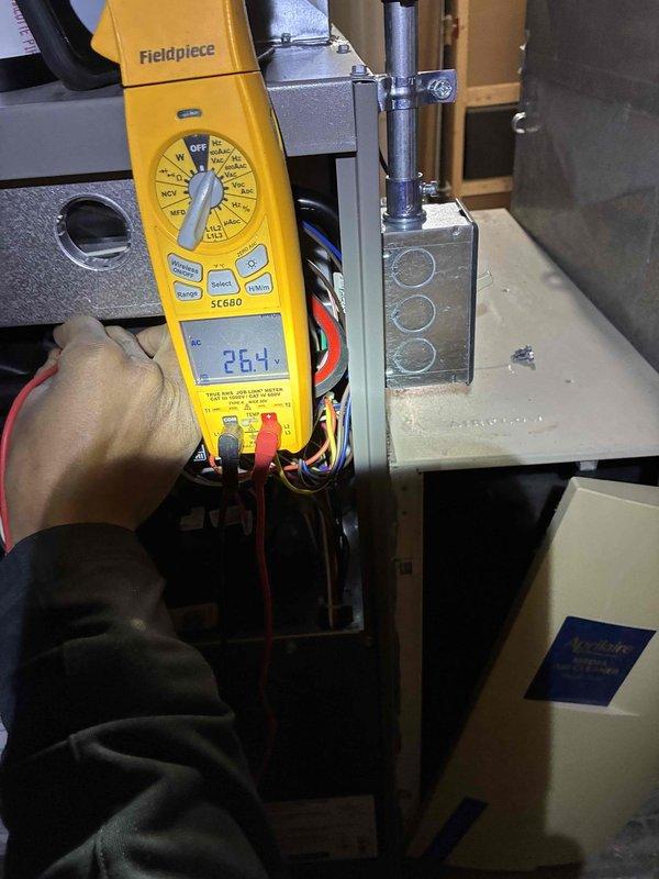 Performed routine maintenance tune-up on Lennox furnace system. Conducted electrical diagnostics using Fieldpiece SC680 multimeter, confirming proper voltage readings at 26.4V. Inspected PVC exhaust venting configuration and verified all connections were secure with no signs of leakage or deterioration.