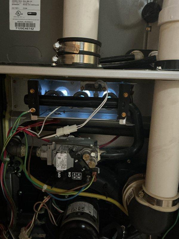 Performed diagnostic inspection of gas furnace with focus on the gas valve assembly and burner components. Inspected wiring connections to control module, verified proper operation of hi/lo gas settings, and confirmed flame sensor functionality. Unit is operating within normal parameters with no issues detected in the combustion process.
