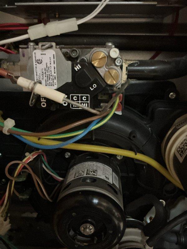 Performed diagnostic inspection of gas furnace with focus on the gas valve assembly and burner components. Inspected wiring connections to control module, verified proper operation of hi/lo gas settings, and confirmed flame sensor functionality. Unit is operating within normal parameters with no issues detected in the combustion process.