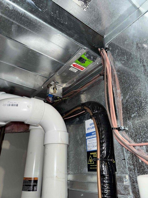 Performed comprehensive tune-up on HVAC system, including inspection of ductwork, refrigerant lines, and drainage components. Examined and tested UV light purification system with warning indicators functioning properly. Inspected control module with digital display and verified proper operation of all electrical connections and control wiring. System is now operating at optimal efficiency with all components properly maintained.