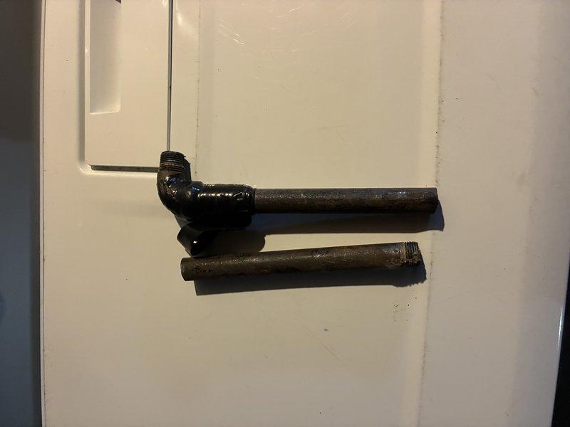 Installed black iron gas piping system with appropriate elbows and fittings, including both horizontal and vertical runs secured against concrete block wall. Completed all connections with proper threading and ensured system integrity through thorough leak testing of all joints and connection points.