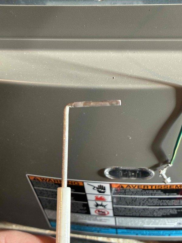 Completed routine tune-up service on customer's HVAC system. Performed temperature readings using digital thermometer, recording 60.8°F at supply register. Inspected internal components and warning labels for proper operation and safety compliance.