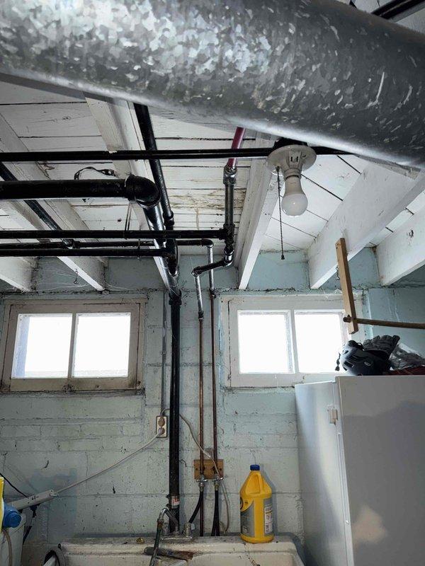 Performed warranty inspection of HVAC system in basement utility area. Examined ductwork, refrigerant lines, and drainage system. Verified proper installation of main air handler and associated piping. No current issues identified with the system operation or installation.