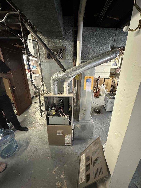 Performed comprehensive inspection of electrical panel and HVAC system in basement utility area. Evaluated existing furnace unit with connected ductwork and adjacent air handler for potential replacement. Documented current circuit breaker configuration and electrical capacity to ensure compatibility with proposed new equipment.