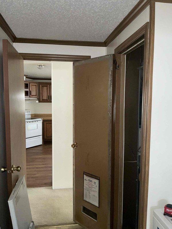 Conducted inspection of existing HVAC equipment through an access panel, revealing outdated unit with visible wiring issues. Provided estimate for complete system replacement, noting the current unit has reached end of service life and replacement would improve energy efficiency while ensuring proper integration with the home's existing doorways and layout.