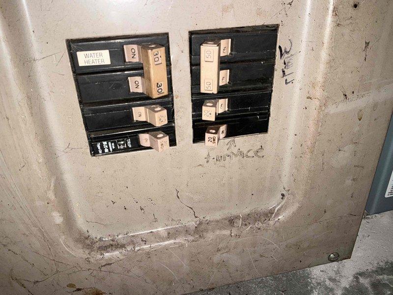 Performed inspection of electrical panels related to HVAC system replacement assessment. Examined two breaker panels showing signs of age and wear. Documented existing circuit configuration, including labeled water heater and furnace connections. Panels exhibited normal deterioration consistent with older installation but remain functional. Photos taken for electrical load capacity evaluation prior to equipment selection and installation planning.