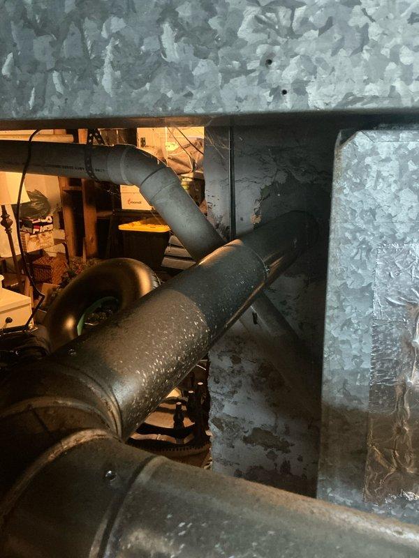 Conducted inspection of existing HVAC system, identifying an aging furnace unit with visible condensation on the exhaust duct indicating potential efficiency issues. Recommended replacement of the current HSC-branded unit with new equipment to improve system performance and reliability.