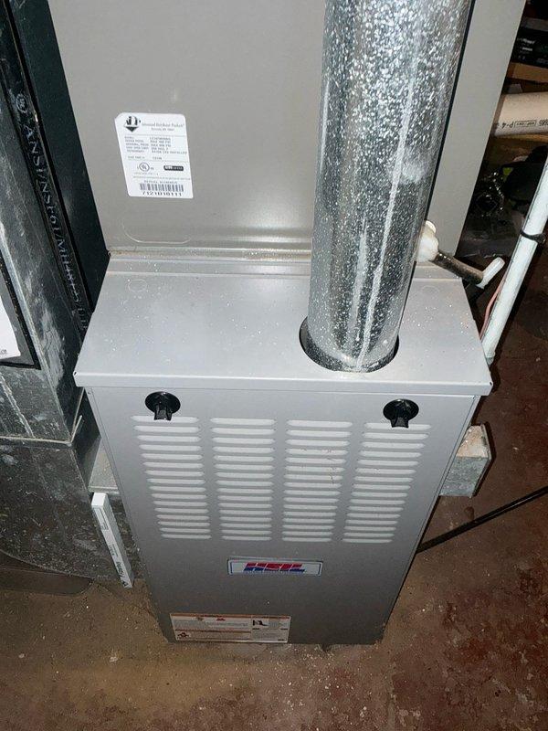 Conducted inspection of existing HVAC system, identifying an aging furnace unit with visible condensation on the exhaust duct indicating potential efficiency issues. Recommended replacement of the current HSC-branded unit with new equipment to improve system performance and reliability.