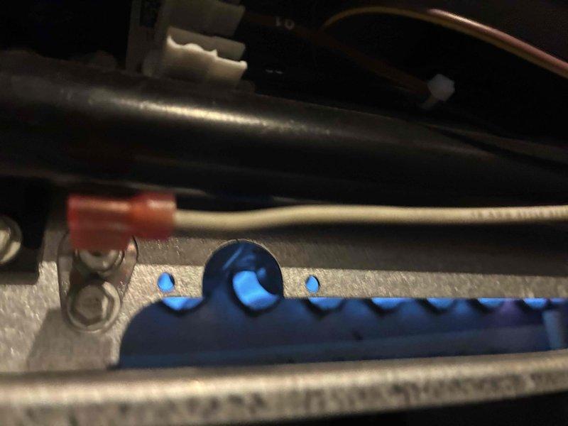 Performed routine maintenance on HVAC system. Inspected furnace components including ignition assembly with blue indicator lights. Utilized hex key to adjust mechanical elements and checked electrical connections. All systems functioning properly after service.