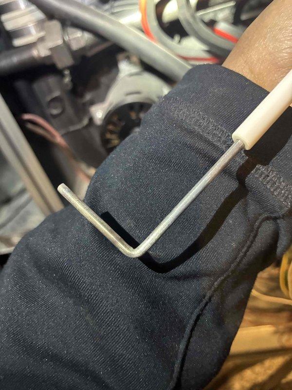 Performed routine maintenance on HVAC system. Inspected furnace components including ignition assembly with blue indicator lights. Utilized hex key to adjust mechanical elements and checked electrical connections. All systems functioning properly after service.