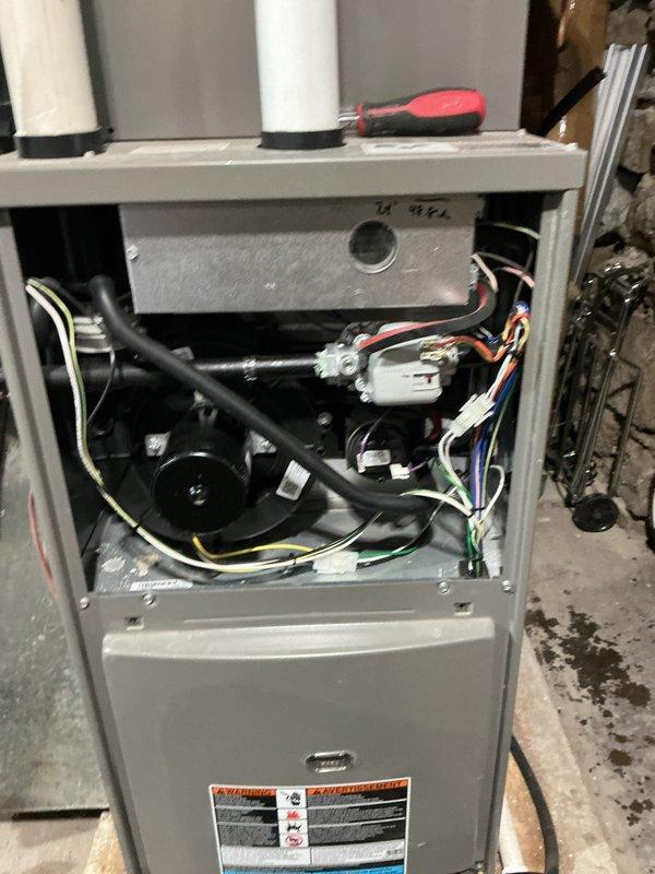 Completed routine HVAC maintenance agreement service on gas furnace system. Inspected internal components including motor assembly, wiring harnesses, and ventilation system. Verified proper operation of PVC drainage/ventilation pipes and examined ductwork integrity in basement installation.