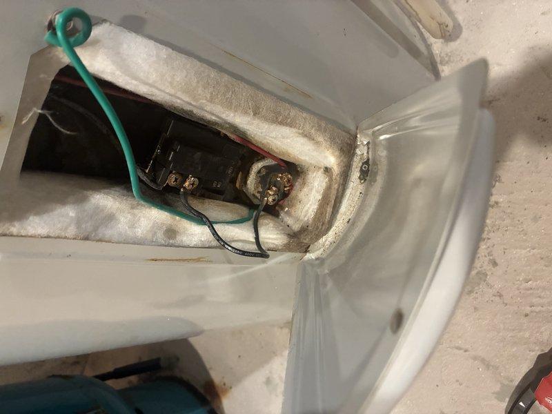 Performed inspection of residential tanked water heater system located in utility room. Examined electrical connections at terminal block by accessing service panel. Verified proper installation of expansion tank and copper supply lines. System appeared to be in good working condition with no visible leaks or deterioration.