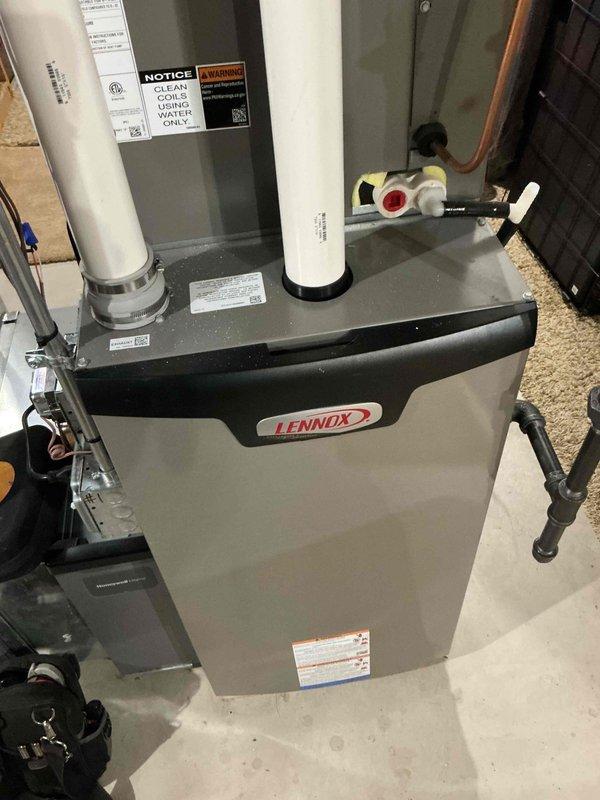 Performed routine maintenance on a Lennox HVAC system, including inspection of the furnace unit and associated ventilation components. Verified proper operation of intake and exhaust PVC pipes, checked all electrical connections, and confirmed system functionality according to manufacturer specifications.