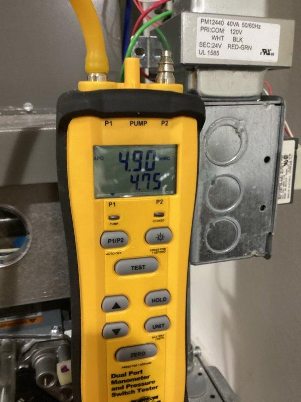 Performed annual maintenance service on HVAC system. Conducted pressure testing using dual port manometer, confirming readings of 4.90 and 4.75 on primary and secondary ports. Inspected PVC condensate drainage piping and associated electrical components including the PM12440 40VA transformer, all found to be in proper working condition.