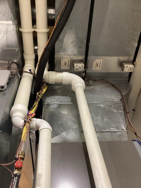 Performed annual maintenance service on HVAC system. Conducted pressure testing using dual port manometer, confirming readings of 4.90 and 4.75 on primary and secondary ports. Inspected PVC condensate drainage piping and associated electrical components including the PM12440 40VA transformer, all found to be in proper working condition.