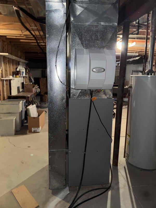 Conducted assessment of existing HVAC system including outdoor Armstrong air conditioning unit showing signs of frost/snow accumulation and aging components. Evaluated basement installation featuring current furnace with attached Aprilaire humidifier and associated ductwork. Prepared comprehensive replacement estimate for complete system upgrade to improve heating/cooling efficiency and resolve potential performance issues before system failure occurs.