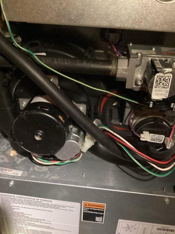 Responded to no-heat call for system under 10 years old. Inspection revealed damaged flooring near the unit and upon examination of the furnace interior, identified a faulty blower motor assembly. Replaced defective motor, reconnected all electrical components, and verified proper system operation with multiple heating cycles.