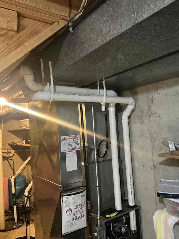 Conducted inspection of existing HVAC system in basement mechanical room. Documented current furnace installation and associated PVC drain/vent piping (Schedule 40 DWV). Photos taken of utility area showing furnace unit with manufacturer labels and the existing white PVC piping infrastructure with proper labeling (Crestline Coextruded Cellular Core PVC DWV IPS SCH 40 Series NSF) for assessment and replacement planning.