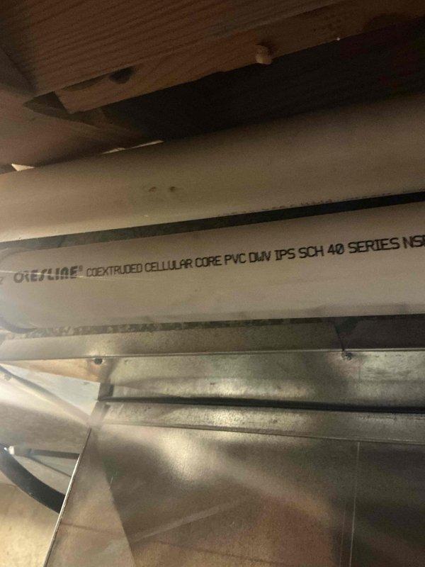 Conducted inspection of existing HVAC system in basement mechanical room. Documented current furnace installation and associated PVC drain/vent piping (Schedule 40 DWV). Photos taken of utility area showing furnace unit with manufacturer labels and the existing white PVC piping infrastructure with proper labeling (Crestline Coextruded Cellular Core PVC DWV IPS SCH 40 Series NSF) for assessment and replacement planning.