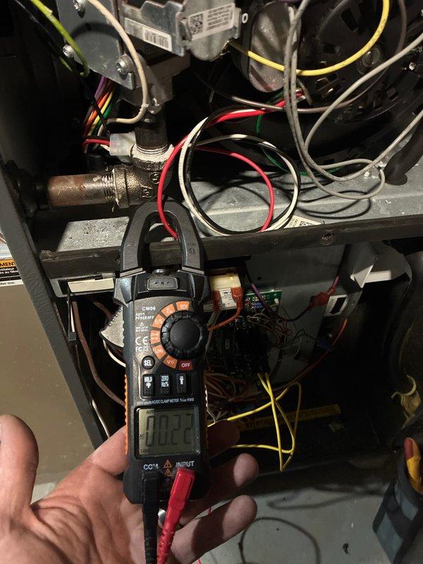Responded to no-heat complaint on aging furnace. Performed diagnostic testing with multimeter, measuring 0.22 amps on the inducer motor. Verified gas valve operation and inspected flame pattern, which showed proper blue flames across all four burners. System is now operating correctly with restored heat output.