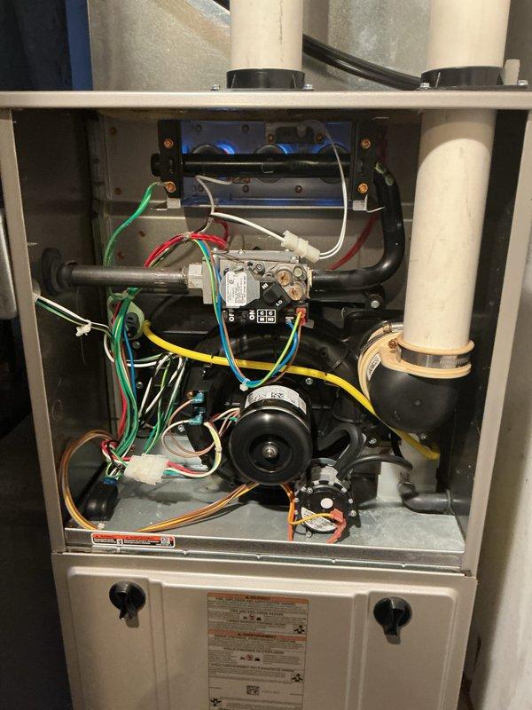 Performed comprehensive tune-up on residential gas furnace. Inspected burner assembly showing proper blue flame pattern and verified all electrical connections were secure. Examined heat exchanger, gas valve assembly, and draft inducer motor - all components functioning within normal parameters.