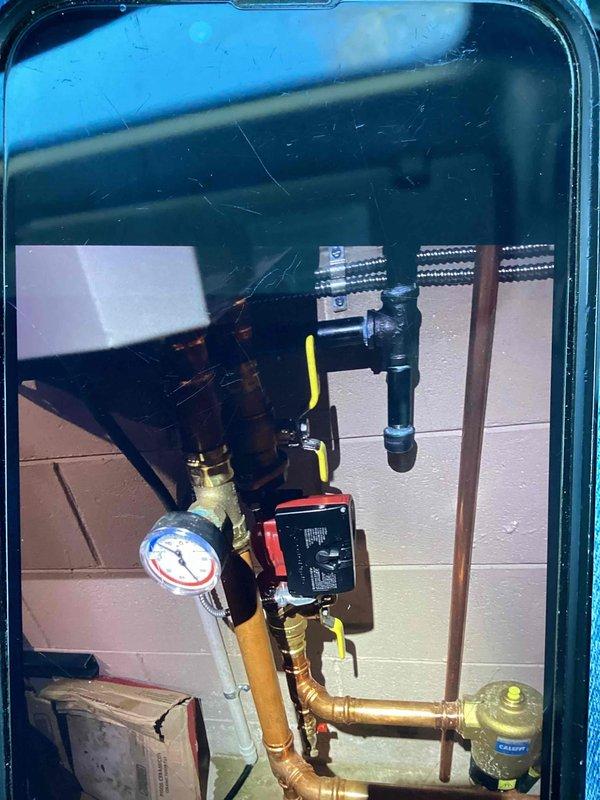 Performed inspection and maintenance on copper hydronic system. Checked pressure gauge readings and verified proper operation of control valves and electronic control unit. All components appear well-maintained with no visible leaks or deficiencies in the piping network.