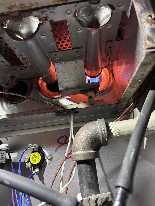 Responded to a "no heat" service call for furnace under 10 years old. Diagnosed failed inducer motor (FASCO brand) with visible dust accumulation. Replaced motor, performed system check, and verified proper burner ignition with normal flame pattern observed. Unit now operating within specifications and producing heat.