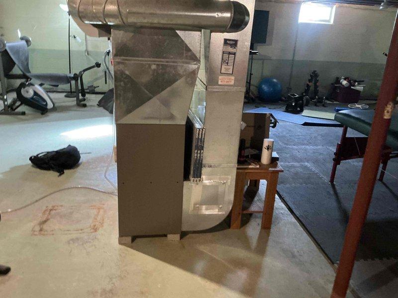 Conducted assessment of existing HVAC system in partially finished basement that doubles as a home gym. Recommended replacement of aging furnace unit with visible wear and outdated efficiency ratings. System requires new ductwork with proper insulation, PVC ventilation pipes, and installation of a humidifier component to improve air quality throughout the home.